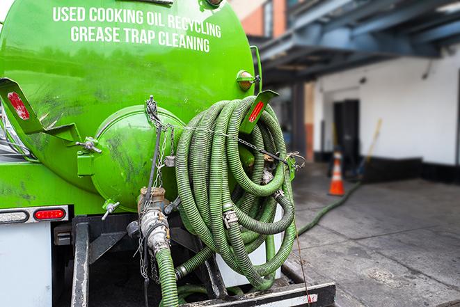 a grease trap pumping service in action at a commercial building in Taft CA